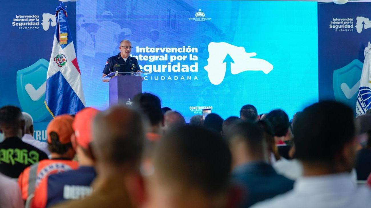 Una persona uniformada habla desde un atril ante asistentes y una pantalla de Seguridad Ciudadana.