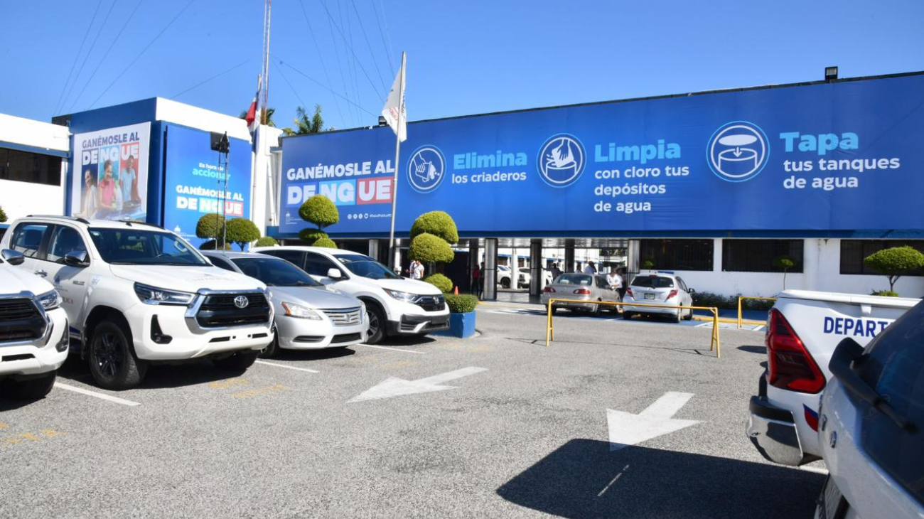 Fachada y estacionamiento de Salud Pública con mensajes de prevención del dengue.